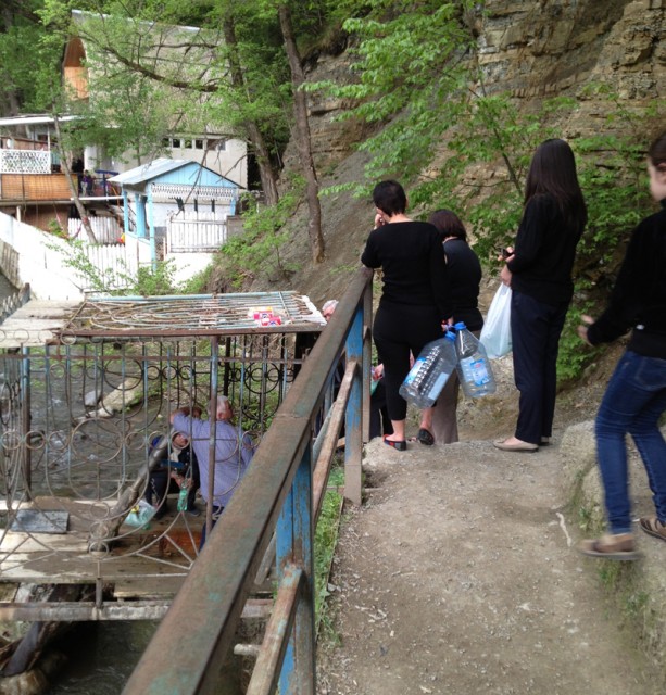 Lining up to fill water bottle from a spring in Borjormi